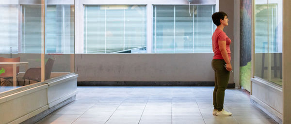 Full length of woman standing in corridor