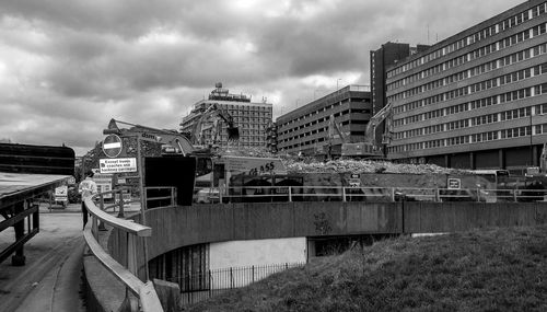 Buildings against cloudy sky