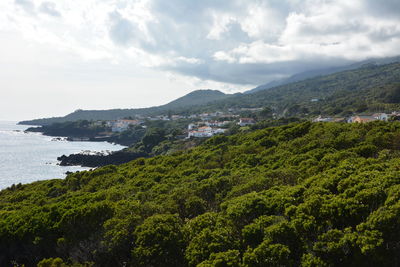 Scenic view of sea and mountains against sky