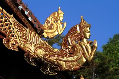 Low angle view of sculptures at roof of buddhist temple