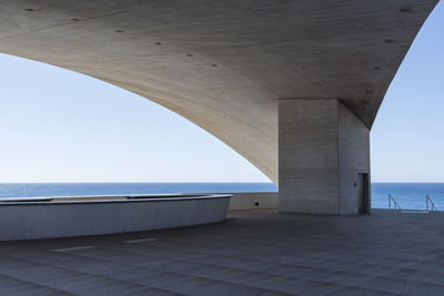 Below view of bridge over sea against clear sky