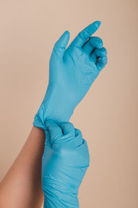 Close-up of human hand against blue background