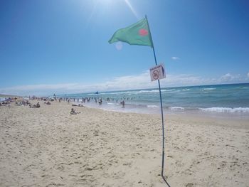 Scenic view of beach against blue sky