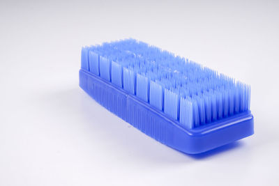 Close-up of blue cleaning brush on gray background