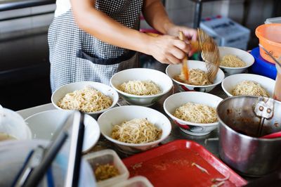 Person preparing noodles at home