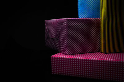 High angle view of illuminated light on table against black background