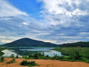 Scenic view of lake and mountains against sky