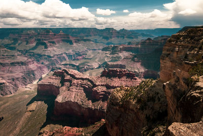 Aerial view of rock formations against cloudy sky