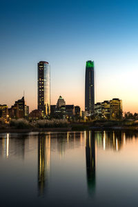 Pond at bicentennial park in the wealthy vitacura district and skyline of buildings, santiago, chile