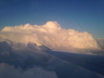 Airplane on landscape against blue sky