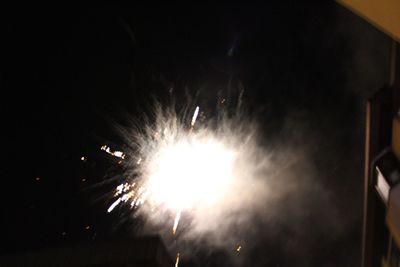 Low angle view of firework display at night