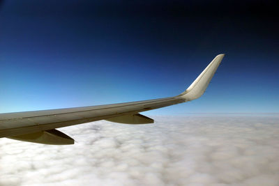 Airplane flying against clear blue sky