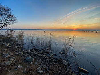 Scenic view of lake against sky during sunset