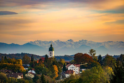 Panoramic view of trees and buildings against sky