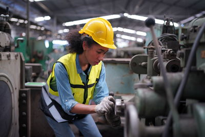 Side view of man working in factory