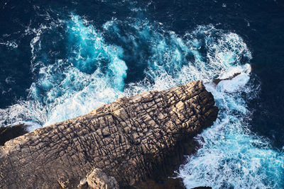 High angle view of waves splashing in sea