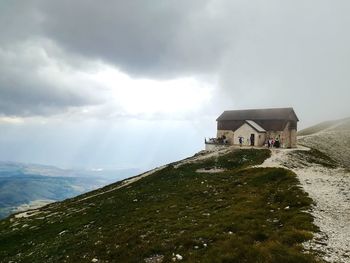 Building on mountain against sky