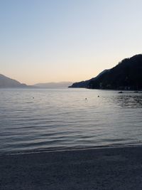 Scenic view of sea against clear sky during sunset