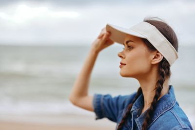 Young woman looking away at beach