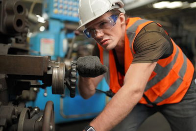 Portrait of male worker standing in the heavy industry manufacturing factory.