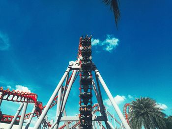 Low angle view of ferris wheel against blue sky