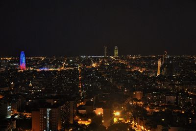 Illuminated cityscape against sky at night