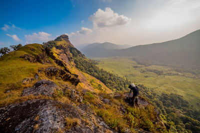 Hiker on mountain against sky