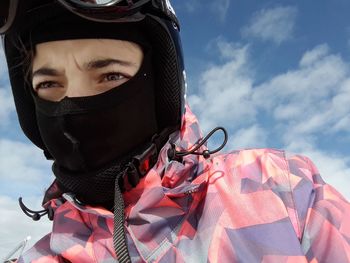 Low angle view of person wearing skiing helmet against sky