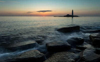 Scenic view of sea against sky during sunset