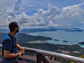 Man looking at sea against sky