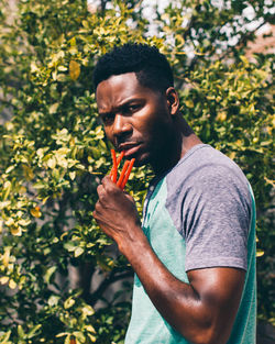 Portrait of young man looking away outdoors