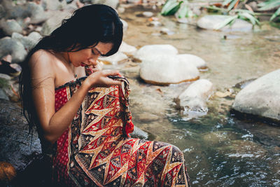 Young woman bathing in river