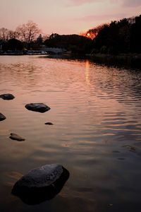 Scenic view of lake against romantic sky at sunset