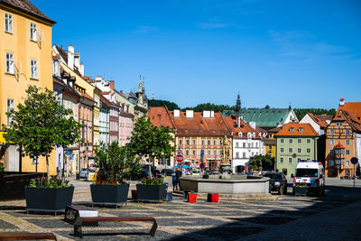 Buildings in city against blue sky