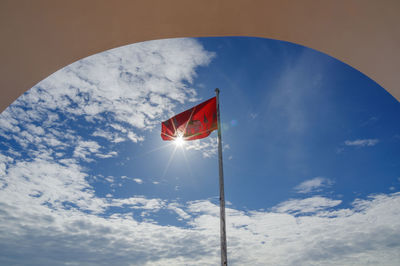 Low angle view of flag against sky