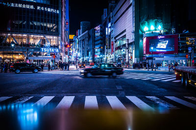 Illuminated city street at night