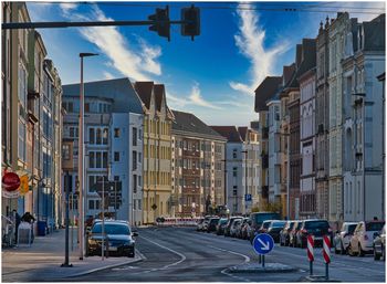 Panoramic view of city street and buildings against sky