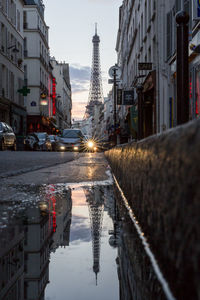 Reflection of buildings in puddle