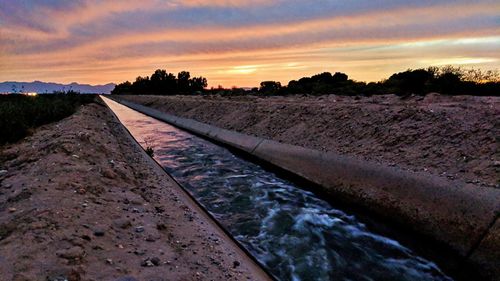Railroad tracks against sky during winter