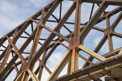 Low angle view of metallic structure against sky