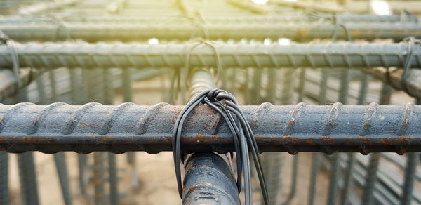 Close-up of metal railing by water