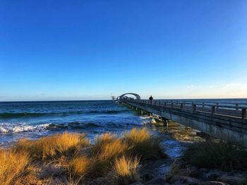 Scenic view of sea against clear blue sky