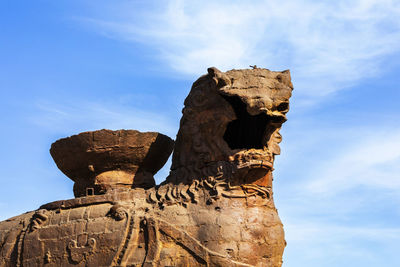 Low angle view of rock formations against sky