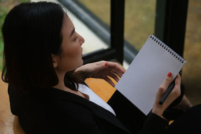 Portrait of woman reading book