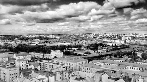 Cityscape against cloudy sky