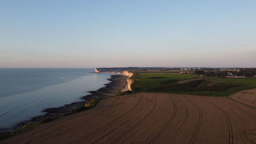 Scenic view of sea against clear sky during sunset