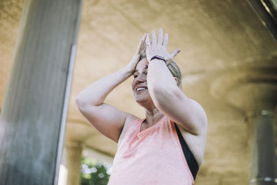 Low angle view of exhausted mature woman during workout