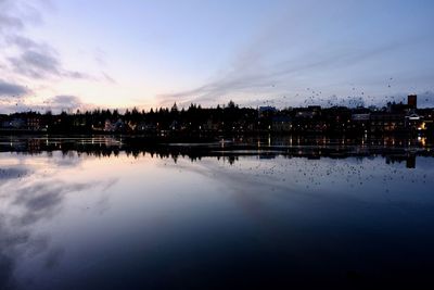 Scenic view of river against sky at dusk