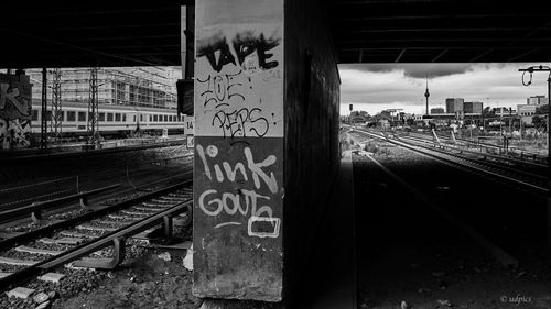 Railway tracks at railroad station against sky