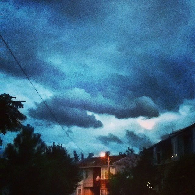 building exterior, sky, architecture, built structure, cloud - sky, cloudy, tree, house, weather, storm cloud, residential structure, residential building, low angle view, cloud, dusk, overcast, silhouette, nature, dramatic sky, beauty in nature